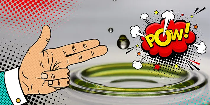 Comic-Hand und „POW!“-Blase neben einem Tropfen, der in eine grünliche Flüssigkeit fällt – Symbolbild für die Wirkung von Spezialschmierstoffen in besonderen Anwendungen